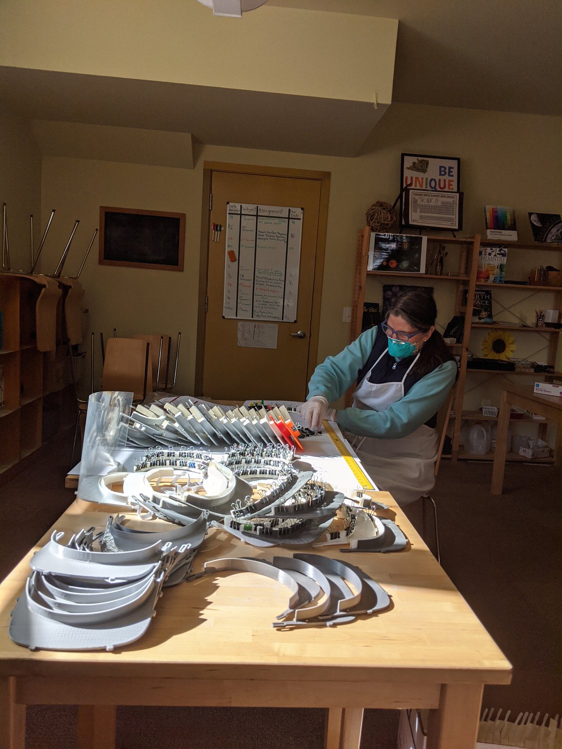 Elizabeth Sherwood works on the masks produced by The Homestead School.